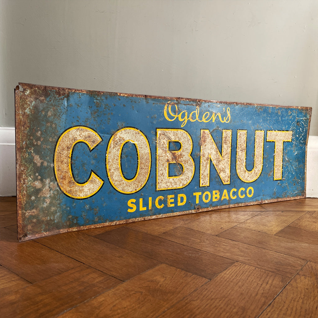 A 1930s Ogden's Cob Nut Sliced Tobacco Tin Sign. In a fantastic bright blue with yellow and black highlights around white type.warm yellow with dark blue type. - SHOP NOW - www.intovintage.co.uk