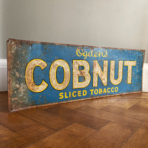 A 1930s Ogden's Cob Nut Sliced Tobacco Tin Sign. In a fantastic bright blue with yellow and black highlights around white type.warm yellow with dark blue type. - SHOP NOW - www.intovintage.co.uk