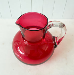 A beautiful Victorian hand blown cranberry glass water jug and glass set, comprising a rounded shaped jug with clear glass handle and four fine tumblers of tapering form. All in excellent condition - SHOP NOW - www.intovintage.co.uk