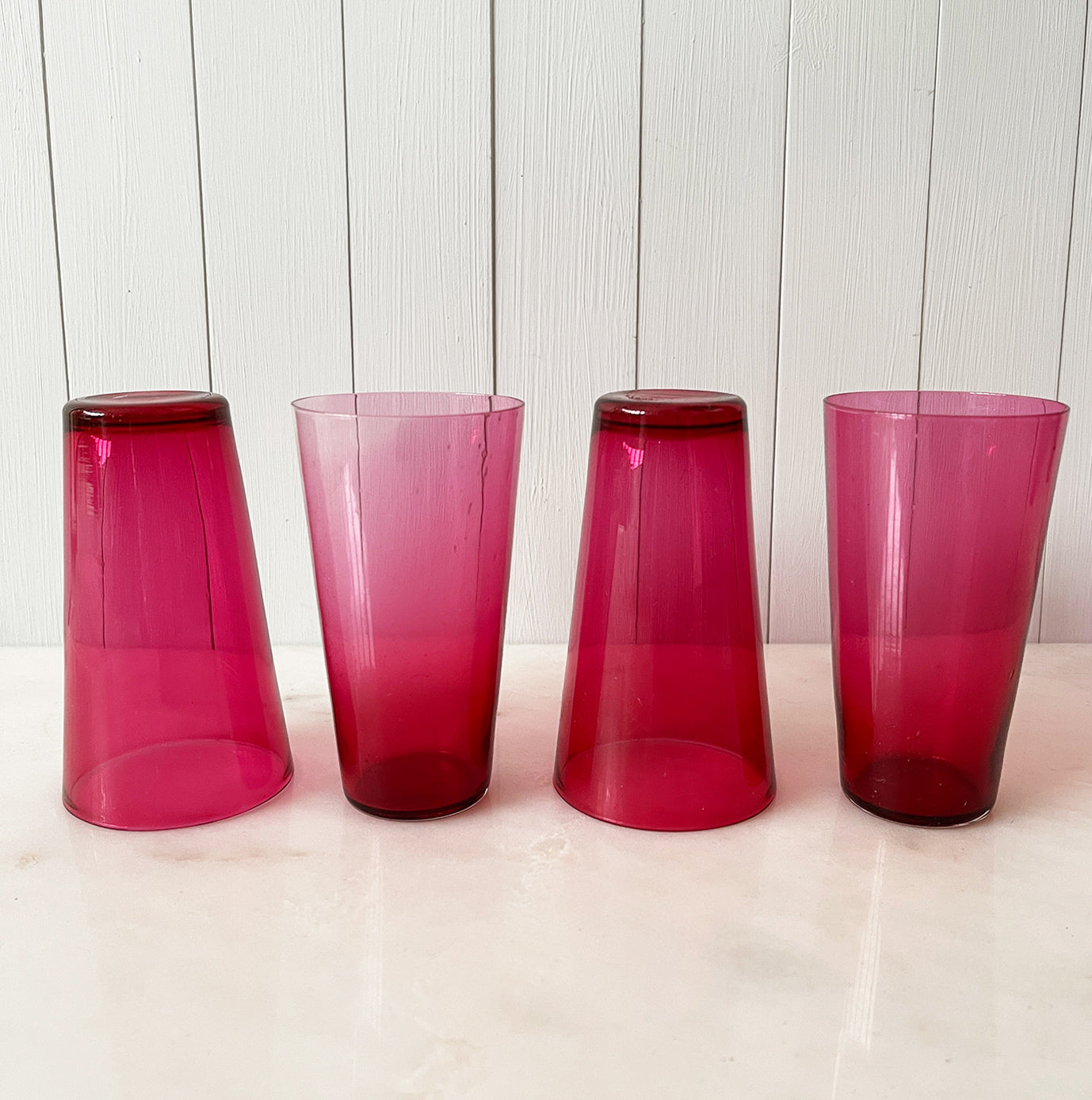 A beautiful Victorian hand blown cranberry glass water jug and glass set, comprising a rounded shaped jug with clear glass handle and four fine tumblers of tapering form. All in excellent condition - SHOP NOW - www.intovintage.co.uk