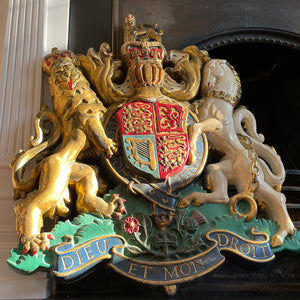 A magnificent, large cast Royal Coat of Arms centred by a crown with lion surmounted and flanked by the lion and unicorn supporting the shield. With foliate surrounded ribbon raised and carrying the motto of the monarch of the United Kingdom, 'Dieu et mon droit' meaning 'God and my right' - SHOP NOW - www.intovintage.co.uk