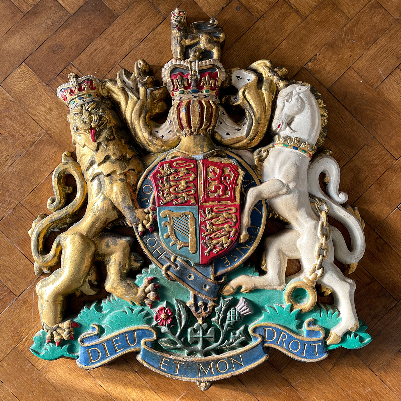 A magnificent, large cast Royal Coat of Arms centred by a crown with lion surmounted and flanked by the lion and unicorn supporting the shield. With foliate surrounded ribbon raised and carrying the motto of the monarch of the United Kingdom, 'Dieu et mon droit' meaning 'God and my right' - SHOP NOW - www.intovintage.co.uk