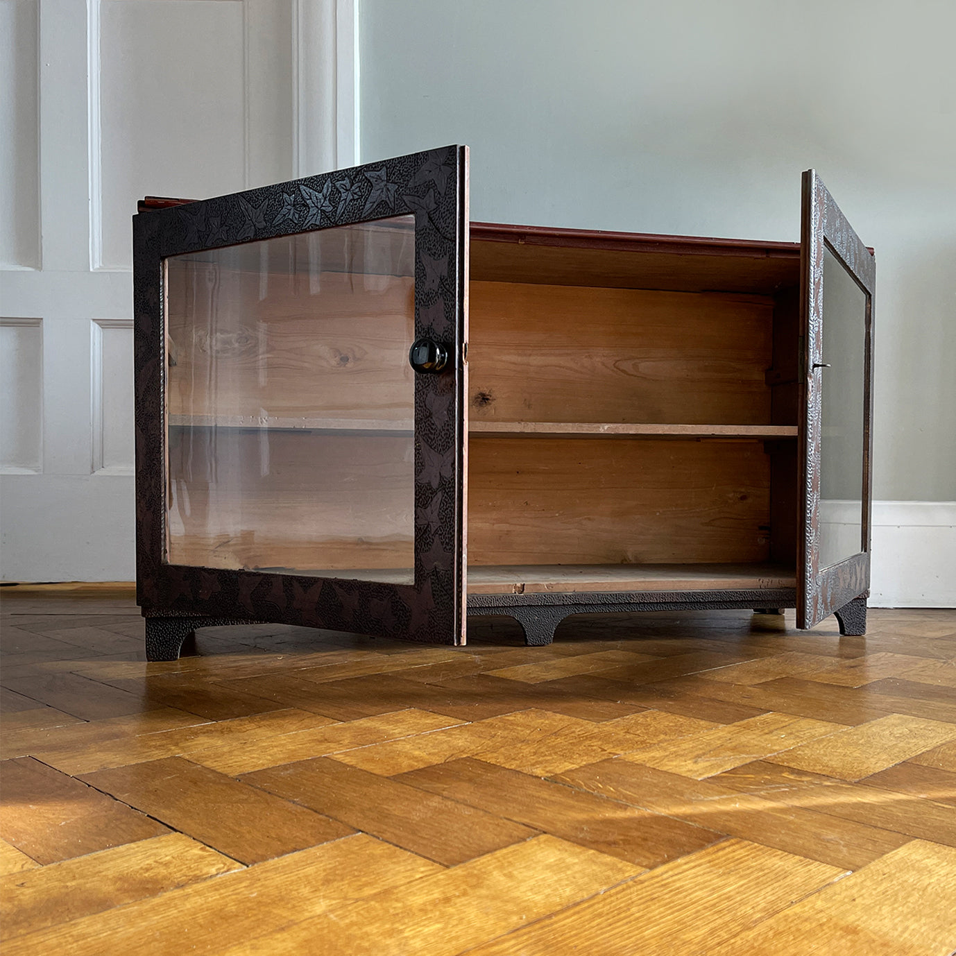 A pretty antique pokerworked glazed cabinet with ivy leaf and dotted decoration to the front. It has its original glass and a black ceramic knob, and still has its original key - SHOP NOW - www.intovintage.co.uk