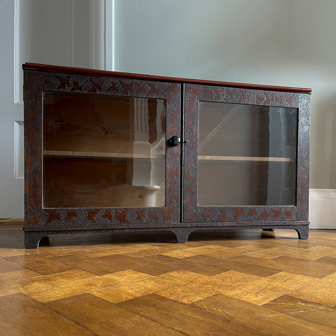 A pretty antique pokerworked glazed cabinet with ivy leaf and dotted decoration to the front. It has its original glass and a black ceramic knob, and still has its original key - SHOP NOW - www.intovintage.co.uk