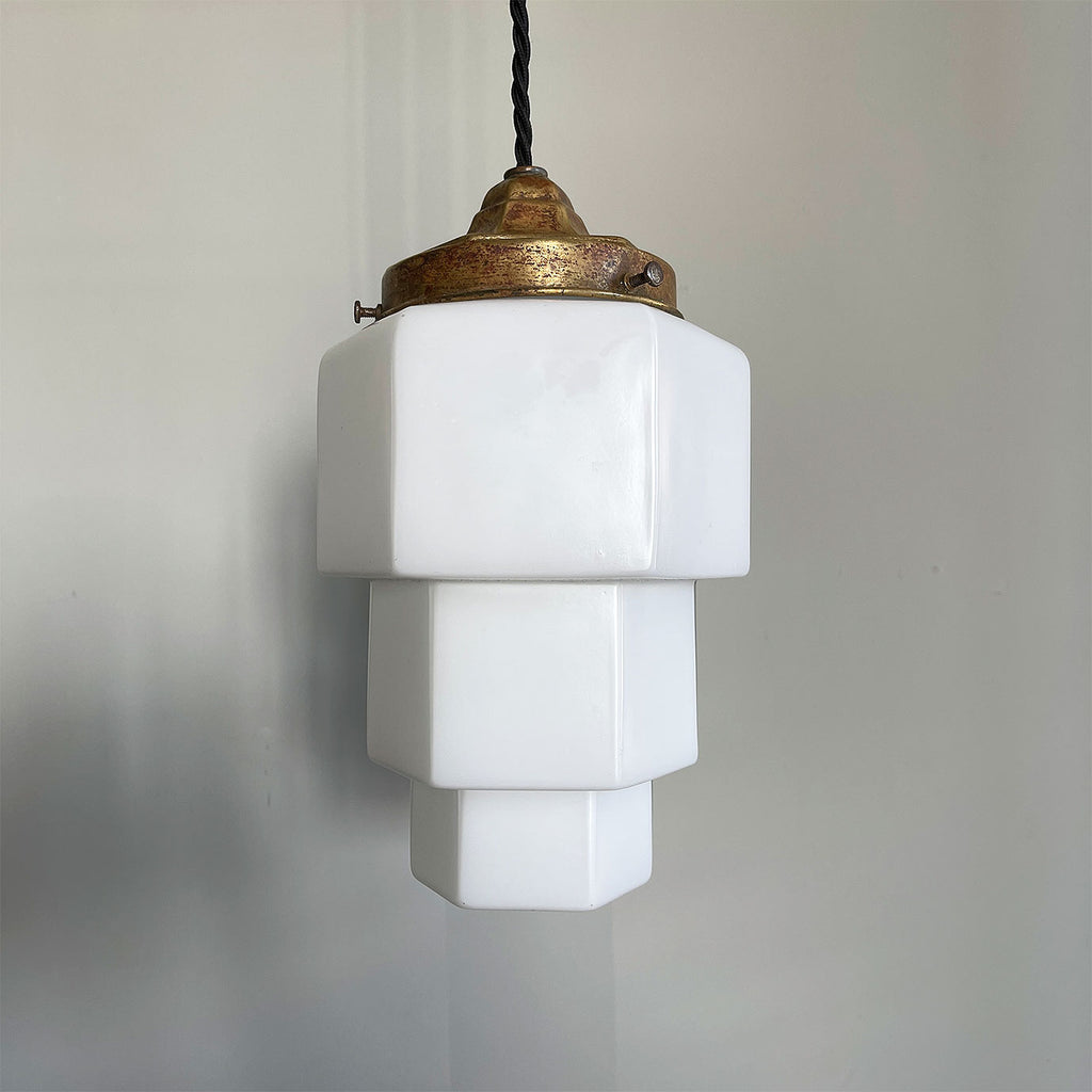 This Art Deco Odeon Style Pendant lamp oozes 30's style with its stepped geometric opaline shade and brass gallery, bringing a sense of deco glamour to any porch or hallway it is hung in. It has new braided black flex and new brass bayonet fitting inside - SHOP NOW - www.intovintage.co.uk