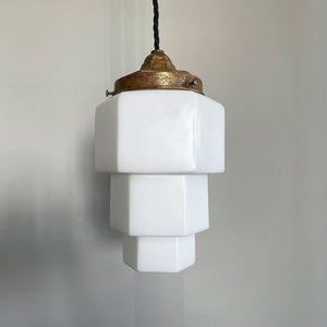 This Art Deco Odeon Style Pendant lamp oozes 30's style with its stepped geometric opaline shade and brass gallery, bringing a sense of deco glamour to any porch or hallway it is hung in. It has new braided black flex and new brass bayonet fitting inside - SHOP NOW - www.intovintage.co.uk