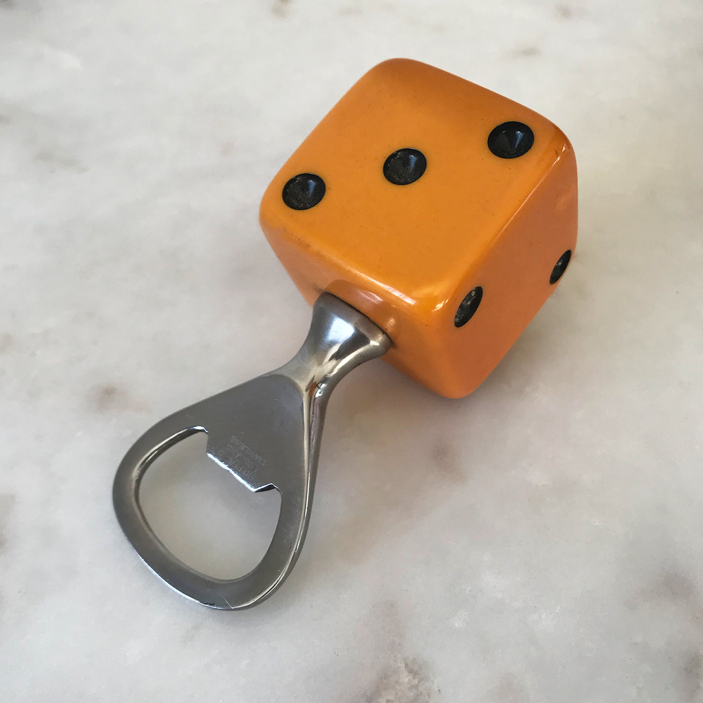 Three deep orange vintage dice all doing a job... One sits atop your bottle replacing the cork, pull off the dice and it becomes a pourer. The second dice is your corkscrew whilst the third dice opens your beer bottles - SHOP NOW - www.intovintage.co.uk