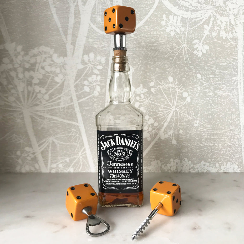 Three deep orange vintage dice all doing a job... One sits atop your bottle replacing the cork, pull off the dice and it becomes a pourer. The second dice is your corkscrew whilst the third dice opens your beer bottles - SHOP NOW - www.intovintage.co.uk