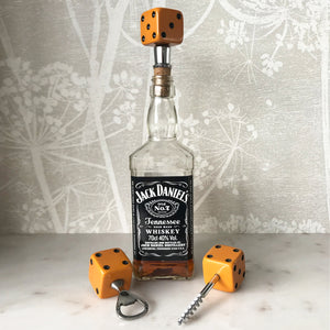 Three deep orange vintage dice all doing a job... One sits atop your bottle replacing the cork, pull off the dice and it becomes a pourer. The second dice is your corkscrew whilst the third dice opens your beer bottles - SHOP NOW - www.intovintage.co.uk