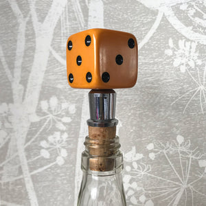 Three deep orange vintage dice all doing a job... One sits atop your bottle replacing the cork, pull off the dice and it becomes a pourer. The second dice is your corkscrew whilst the third dice opens your beer bottles - SHOP NOW - www.intovintage.co.uk