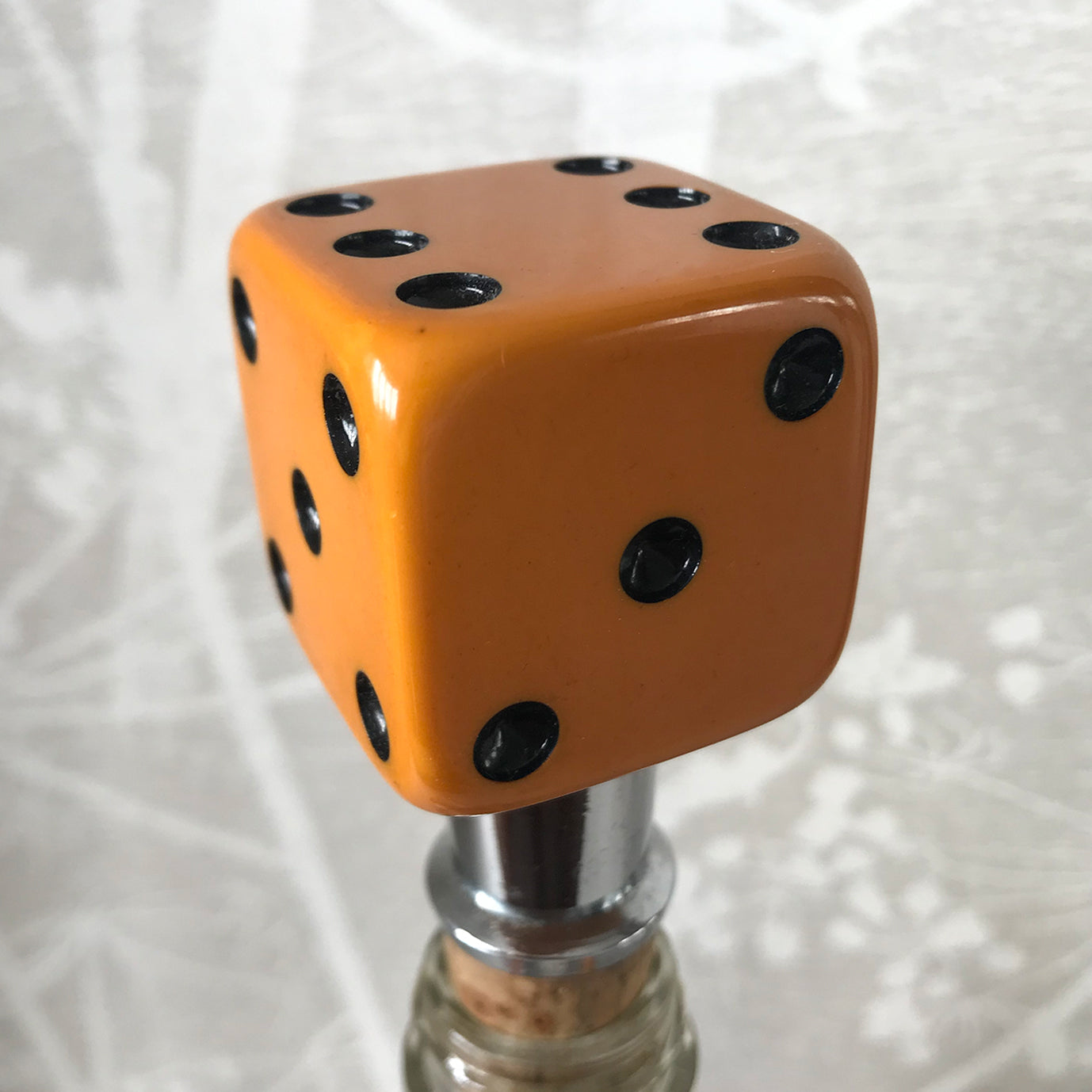 Three deep orange vintage dice all doing a job... One sits atop your bottle replacing the cork, pull off the dice and it becomes a pourer. The second dice is your corkscrew whilst the third dice opens your beer bottles - SHOP NOW - www.intovintage.co.uk