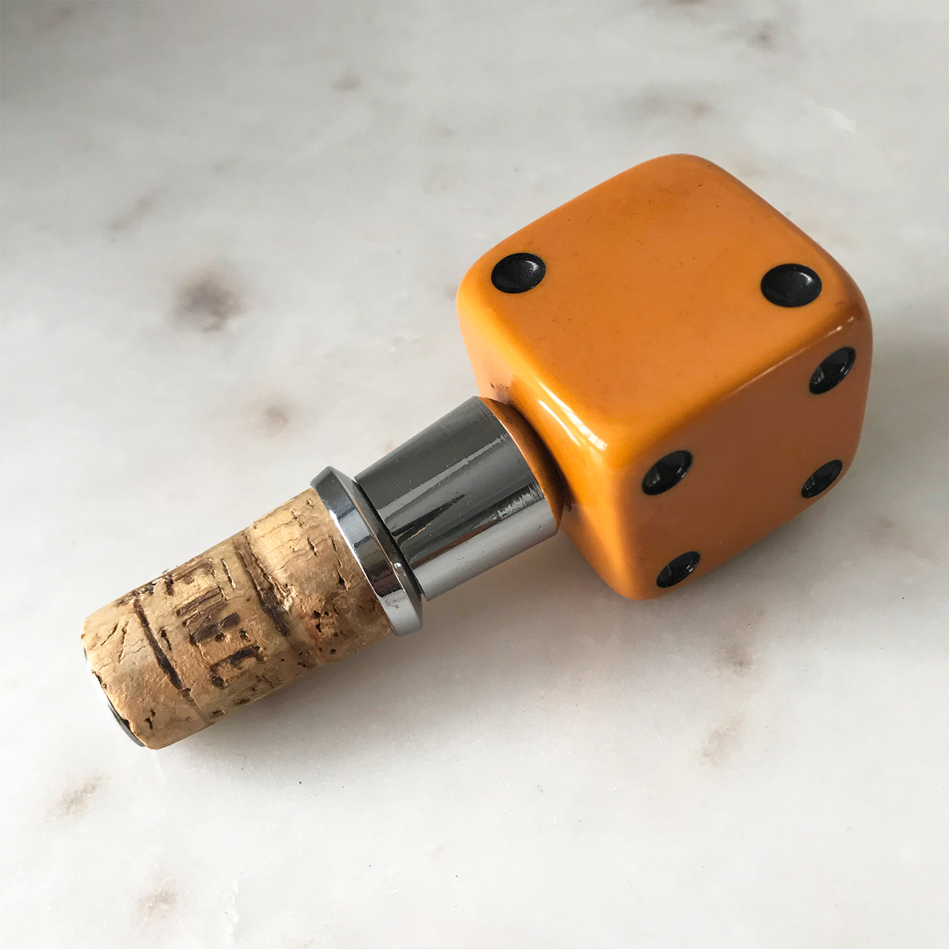 Three deep orange vintage dice all doing a job... One sits atop your bottle replacing the cork, pull off the dice and it becomes a pourer. The second dice is your corkscrew whilst the third dice opens your beer bottles - SHOP NOW - www.intovintage.co.uk