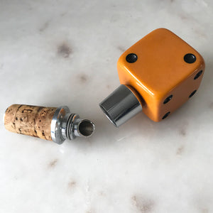 Three deep orange vintage dice all doing a job... One sits atop your bottle replacing the cork, pull off the dice and it becomes a pourer. The second dice is your corkscrew whilst the third dice opens your beer bottles - SHOP NOW - www.intovintage.co.uk