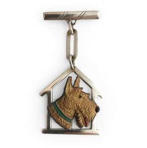 Lovely silver and plastic Art Deco pin. The early plastic dogs head sits on a silver house shaped kennel with chain and pin. Marked Silver - SHOP NOW - www.intovintage.co.uk