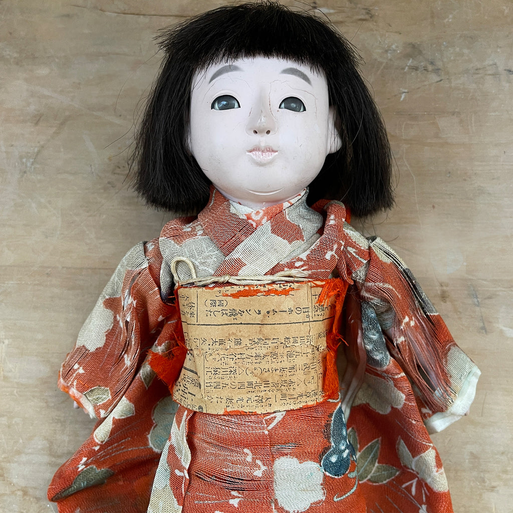 A beautiful time worn Japanese Ichimatsu doll crafted in Kyoto, circa 1930. Dressed in a faded and worn red silk kimono. She has glass eyes, articulated limbs and squeaks when you press her tummy. Her black straight hair is cut and combed in the fashion of Taisho era (1912-1924 - SHOP NOW - www.intovintage.co.uk