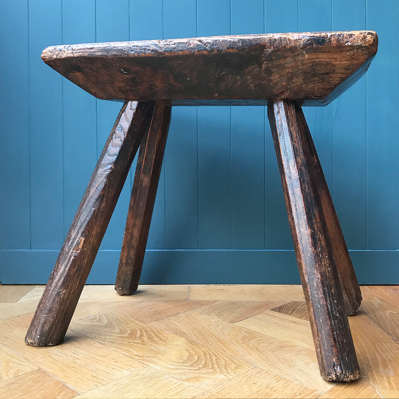 A very old Antique hand carved Elm Milking Stool with wonder colour and wear to the woods surface. Very solid and sitting on four tapered straight edged legs. The seat itself has a great depth to it with pegs and driven wedges. A beautiful piece -SHOP NOW - www.intovintage.co.uk