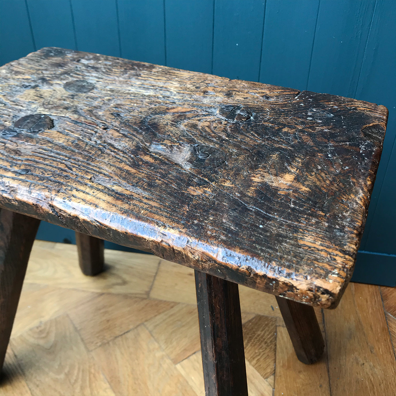 A very old Antique hand carved Elm Milking Stool with wonder colour and wear to the woods surface. Very solid and sitting on four tapered straight edged legs. The seat itself has a great depth to it with pegs and driven wedges. A beautiful piece -SHOP NOW - www.intovintage.co.uk