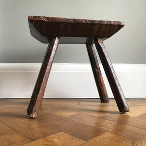 A very old Antique hand carved Elm Milking Stool with wonder colour and wear to the woods surface. Very solid and sitting on four tapered straight edged legs. The seat itself has a great depth to it with pegs and driven wedges. A beautiful piece -SHOP NOW - www.intovintage.co.uk
