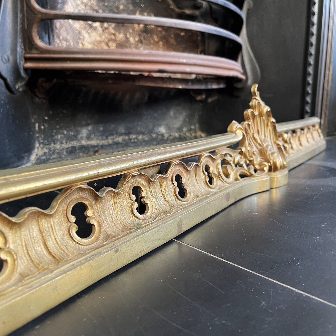 Victorian Gilded Cast Brass Fireplace Ash Keep with Its Rococo styling adding a touch of grandeur to any fireplace. It sits across the floor of the hearth below the basket stopping the ash spill out over the front of the fireplace. Good looking and practical too - SHOP NOW - www.intovintage.co.uk