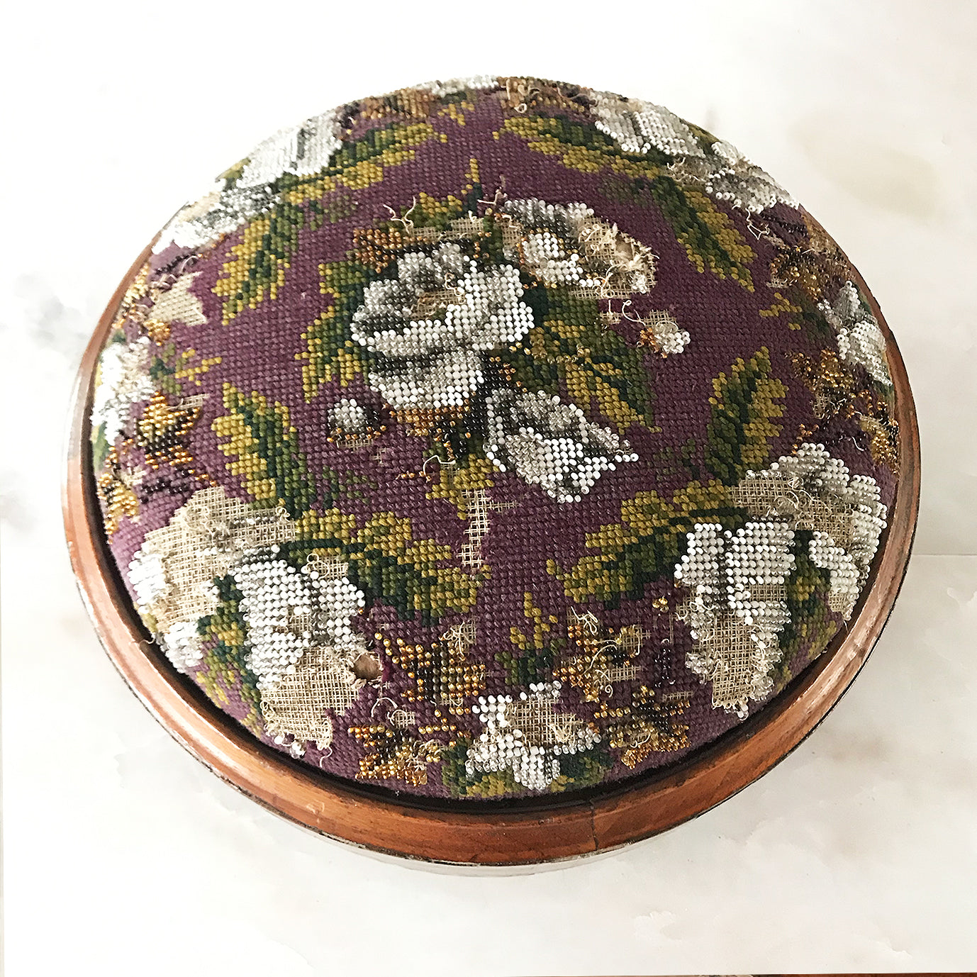 Pretty pair of Edwardian Foot Stools. Veneered mahogany bases with a chevron detail and ceramic feet. The tops are finished in a nicely coloured flower and leaf tapestry material with sewn in beadwork - SHOP NOW - www.intovintage.co.uk