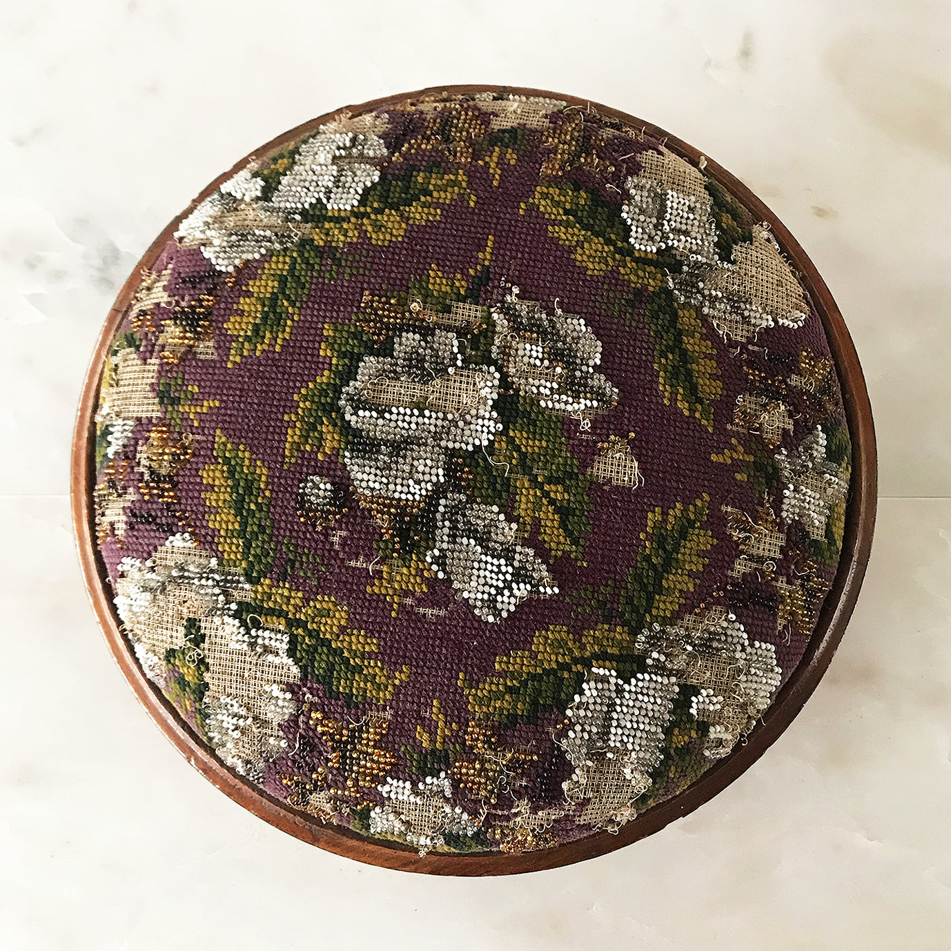Pretty pair of Edwardian Foot Stools. Veneered mahogany bases with a chevron detail and ceramic feet. The tops are finished in a nicely coloured flower and leaf tapestry material with sewn in beadwork - SHOP NOW - www.intovintage.co.uk