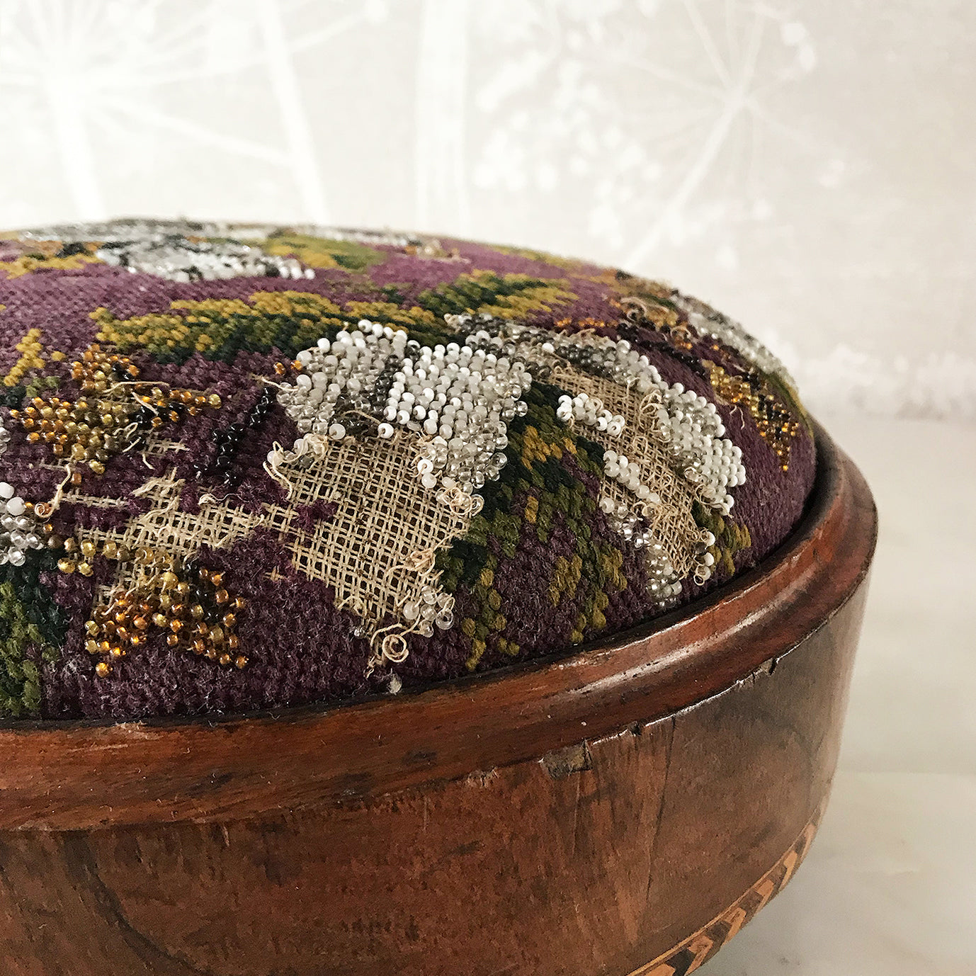Pretty pair of Edwardian Foot Stools. Veneered mahogany bases with a chevron detail and ceramic feet. The tops are finished in a nicely coloured flower and leaf tapestry material with sewn in beadwork - SHOP NOW - www.intovintage.co.uk