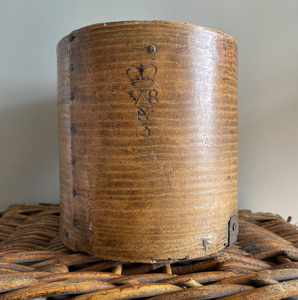 A Victorian Grain Measure. Constructed from yew wood with metal strapping. Marked with the Victorian Crown and the words 'Co LEICESTER' on the reverse