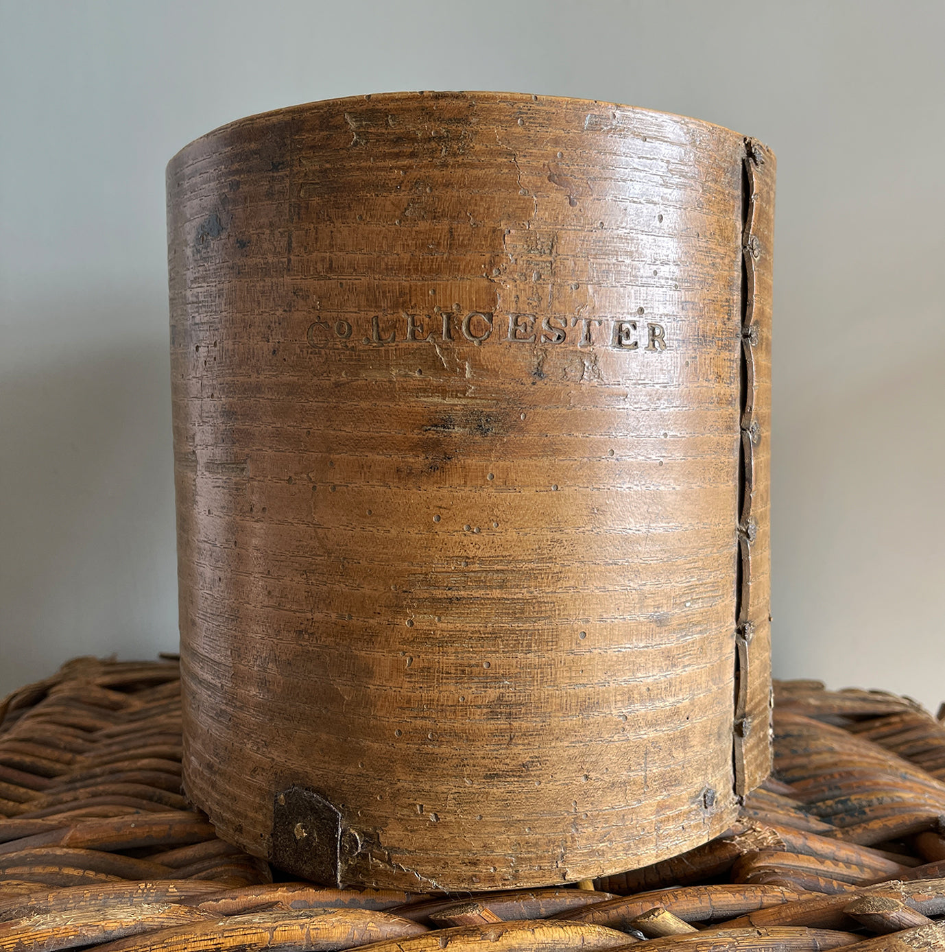 A Victorian Grain Measure. Constructed from yew wood with metal strapping. Marked with the Victorian Crown and the words 'Co LEICESTER' on the reverse