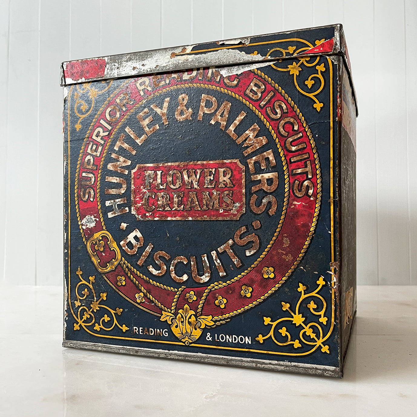 An Edwardian Huntley & Palmer’s large square Biscuit tin that would have been used in a shop to store biscuits for sale. Fantastic typography to the front with well preserved colourful print - SHOP NOW - www.intovintage.co.uk