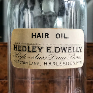 Vintage Clear Apothecary Bottle with an original paper label from Hedley E. Dwelly, High-Class Drug Stores, 41, Acton Lane, Harlesden. N.W. - SHOP NOW - www.intovintage.co.uk