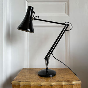 An early 1970s Herbert Terry Model 90 Adjustable Desk Lamp in black. The fluted shade has a push button switch to the top, the side arms are constructed from steel with nylon linkages. The small footprint base has a steel cover. Marked Herbert Terry to the lower arm. A smart looking lamp for the home or office. - SHOP NOW - www.intovintage.co.uk