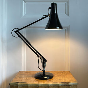 An early 1970s Herbert Terry Model 90 Adjustable Desk Lamp in black. The fluted shade has a push button switch to the top, the side arms are constructed from steel with nylon linkages. The small footprint base has a steel cover. Marked Herbert Terry to the lower arm. A smart looking lamp for the home or office. - SHOP NOW - www.intovintage.co.uk