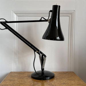 An early 1970s Herbert Terry Model 90 Adjustable Desk Lamp in black. The fluted shade has a push button switch to the top, the side arms are constructed from steel with nylon linkages. The small footprint base has a steel cover. Marked Herbert Terry to the lower arm. A smart looking lamp for the home or office. - SHOP NOW - www.intovintage.co.uk