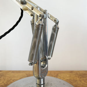 A 1960s Herbert Terry Apex 75 Adjustable Desk Lamp in bare metal. Three capped silver springs and side arms constructed from aluminium with nylon linkages. The fluted shade has a rocker switch to the top - SHOP NOW - www.intovintage.co.uk