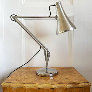 A 1960s Herbert Terry Apex 75 Adjustable Desk Lamp in bare metal. Three capped silver springs and side arms constructed from aluminium with nylon linkages. The fluted shade has a rocker switch to the top - SHOP NOW - www.intovintage.co.uk