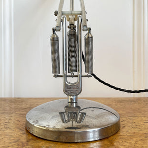 A 1960s Herbert Terry Apex 75 Adjustable Desk Lamp in bare metal. Three capped silver springs and side arms constructed from aluminium with nylon linkages. The fluted shade has a rocker switch to the top - SHOP NOW - www.intovintage.co.uk