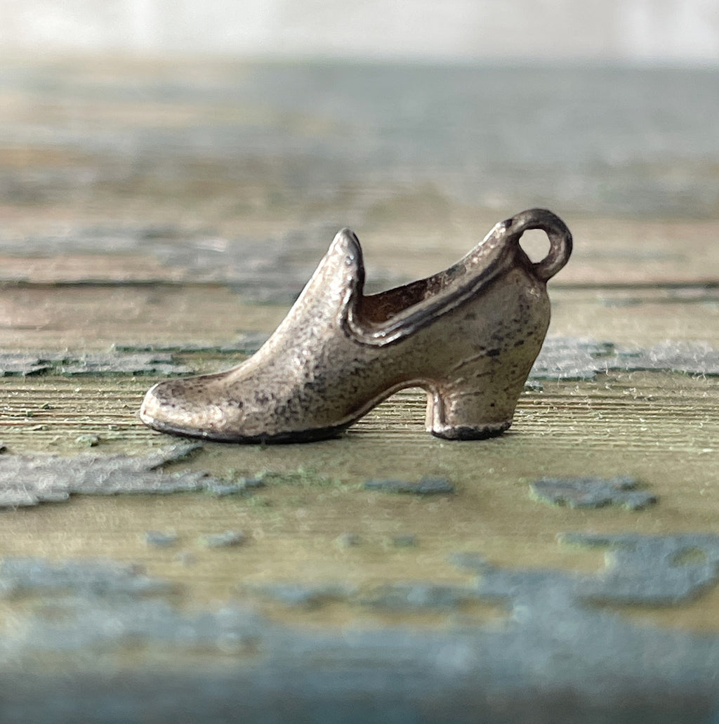 An Advertising Shoe Charm for The Hood Rubber Company. This delightful little shoe has the words 'Hoods Rubbers' on its' sole - SHOP NOW - www.intovintage.co.uk