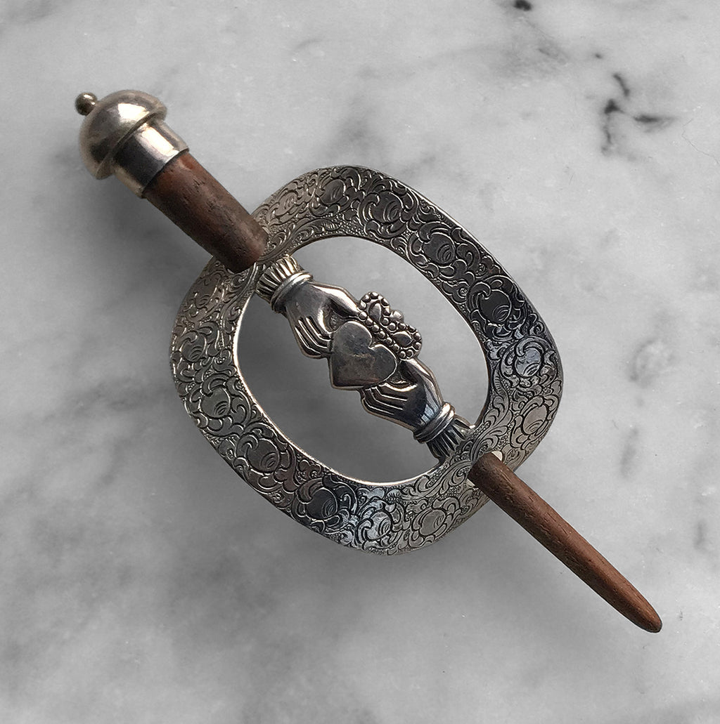 Charming Iris Silver & Wood Claddagh Hair Clasp. The marked 925 (silver) ring is beautifully decorated around the outer edge with the Irish emblem of two hands holding a heart which depicts love, loyalty, and friendship - SHOP NOW - www.intovintage.co.uk