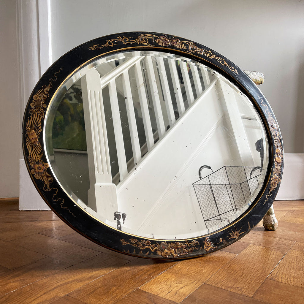 An Antique quality decorated black lacquer oval wall mirror. The original mirrored glass is beveled, has good foxing and is in good condition - SHOP NOW - www.intovintage.co.uk
