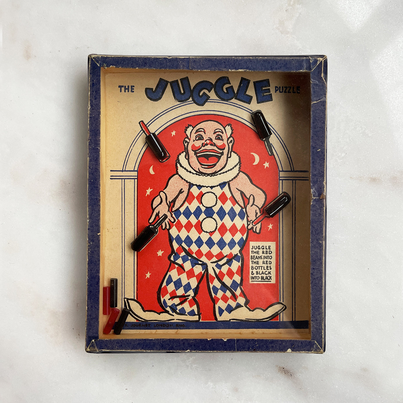 A Vintage Juggle Puzzle by R.Journet & Co. Can you Juggle the red beans in to the red bottles and the black beans into the black? - SHOP NOW - www.intovintage.co.uk