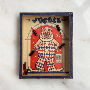 A Vintage Juggle Puzzle by R.Journet & Co. Can you Juggle the red beans in to the red bottles and the black beans into the black? - SHOP NOW - www.intovintage.co.uk