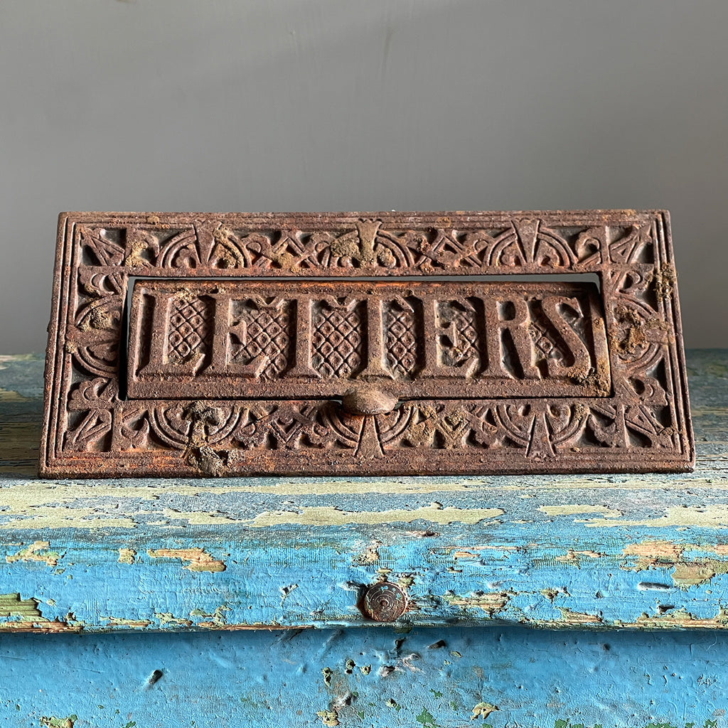 A large cast iron letter plate by Archibald Kenrick, with weighted letters flap for flip back into place when used. Depicting the word letters with patterning around the edge - SHOP NOW - www.intovintage.co.uk