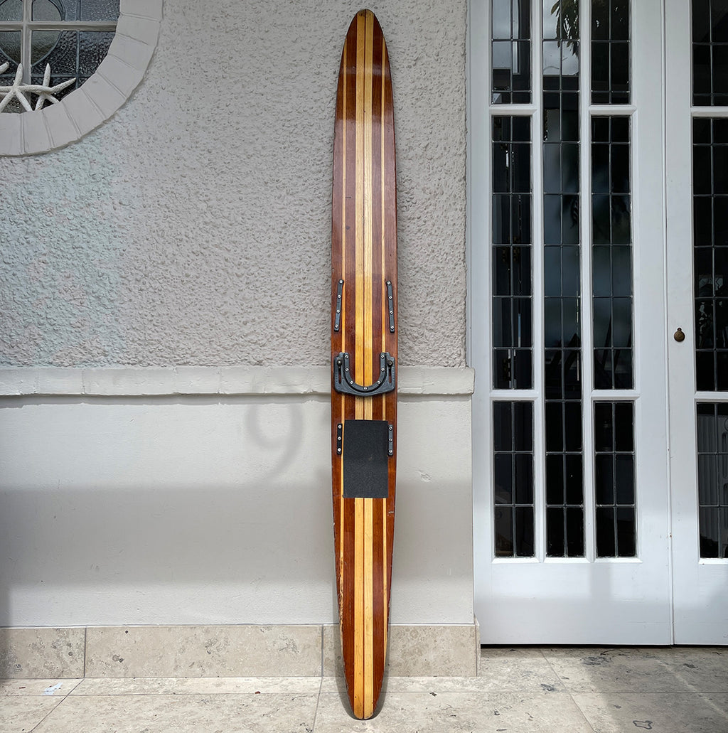 Uber cool vintage wooden mono water ski. It has a wonderful warm tone to the two tone wood. We have removed the old rubber footholds and given it a polish so that it can be seen in its full glory when mounted on the wall - SHOP NOW - www.intovintage.co.uk