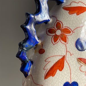 An Imari Moon Vase with a hand painted butterfly design. Beautiful blue and red designs to both sides. Decorative blue zig zag styled handles come down each of the sides. A striking decorative piece that would bring a splash of colour to any space - SHOP NOW - www.intovintage.co.uk