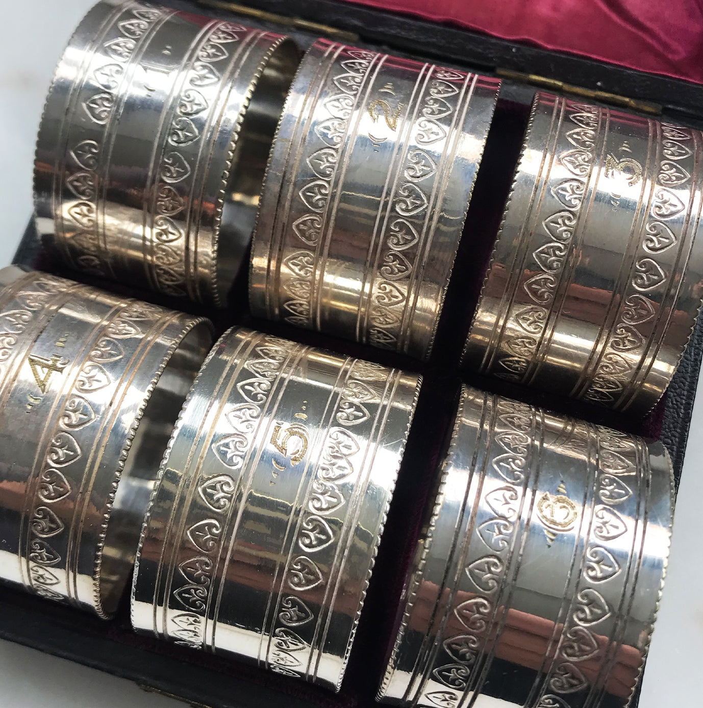 Nice set of 6 Edwardian Napkin Rings in a leather and satin case. Each ring is numbered from 1 to 6. Unmarked but probably silver plated - SHOP NOW - www.intovintage.co.uk