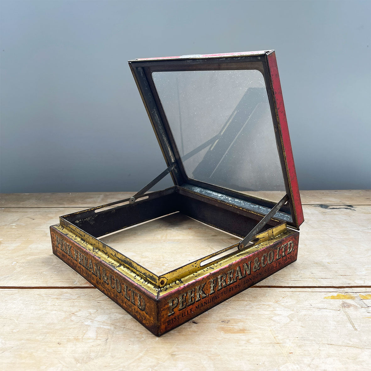 A Peak Frean & Co Biscuit Tin Lid with glass top display window. Original glass and fantastic aged patina to graphics - SHOP NOW - www.intovintage.co.uk