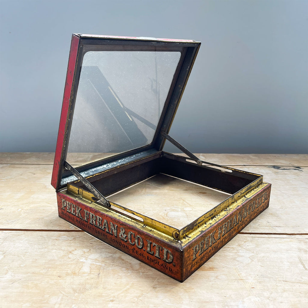 A Peak Frean & Co Biscuit Tin Lid with glass top display window. Original glass and fantastic aged patina to graphics - SHOP NOW - www.intovintage.co.uk