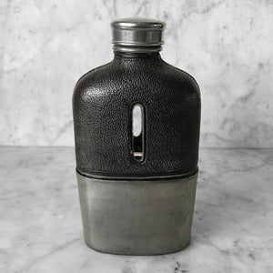 Rather nice Edwardian Gentleman's Flask. Pewter top and cup that sits snuggly over the glass bottle. The top of the bottle is finished in leather, finely stitched at the seems with two small peep hole windows each side so that you can keep an eye on your tipple level! SHOP NOW - www.intovintage.co.uk
