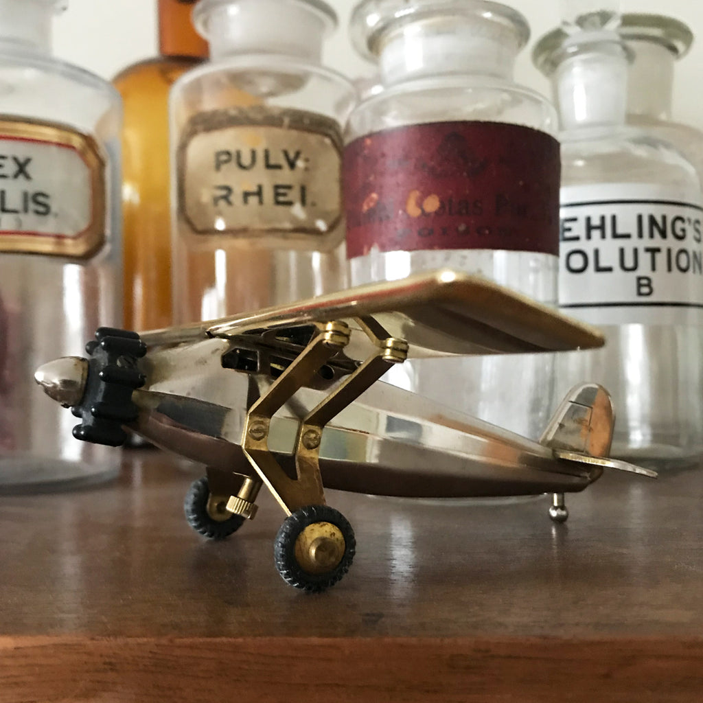 Working rare Spirit of St Louis airplane table lighter made by the Swank company of 1950s out of Japan. Amazing vintage piece in perfect working condition. This is a semi-automatic piece. Just spin the nose cone, and the cockpit flips open activating the lighter - SHOP NOW - www.intovintage.co.uk