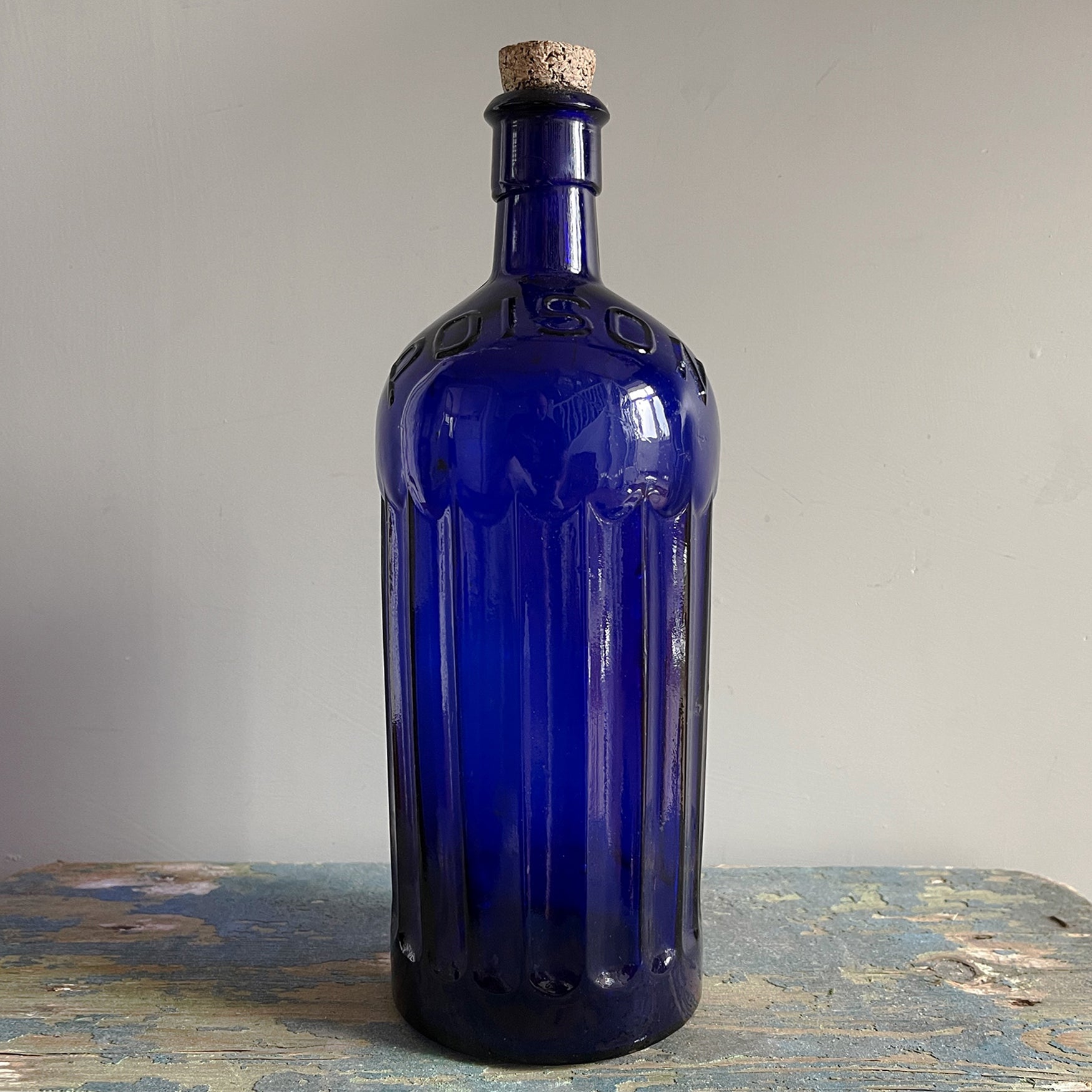 A Large Victorian Poison Bottle with cork stopper. It has fluted sides and two moulded 'POISON' words across the front and back shoulders. These bottles look great displayed in the bathroom or in a curio cabinet - SHOP NOW - www.intovintage.co.uk